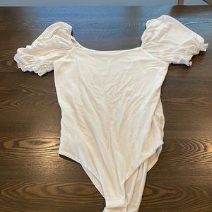 White bodysuit with ruffle sleeves from Pink Lily